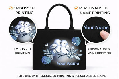 STYLLURE Customised Adorable White Lovebirds illustration with Delicate Floral Accents on Black Canvas Tote Bag with Name Print, Premium Handbag for Women, 16x12x5 inches, Fits 15.6 inch Laptop